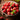 Bowl of small fruits on a wooden table